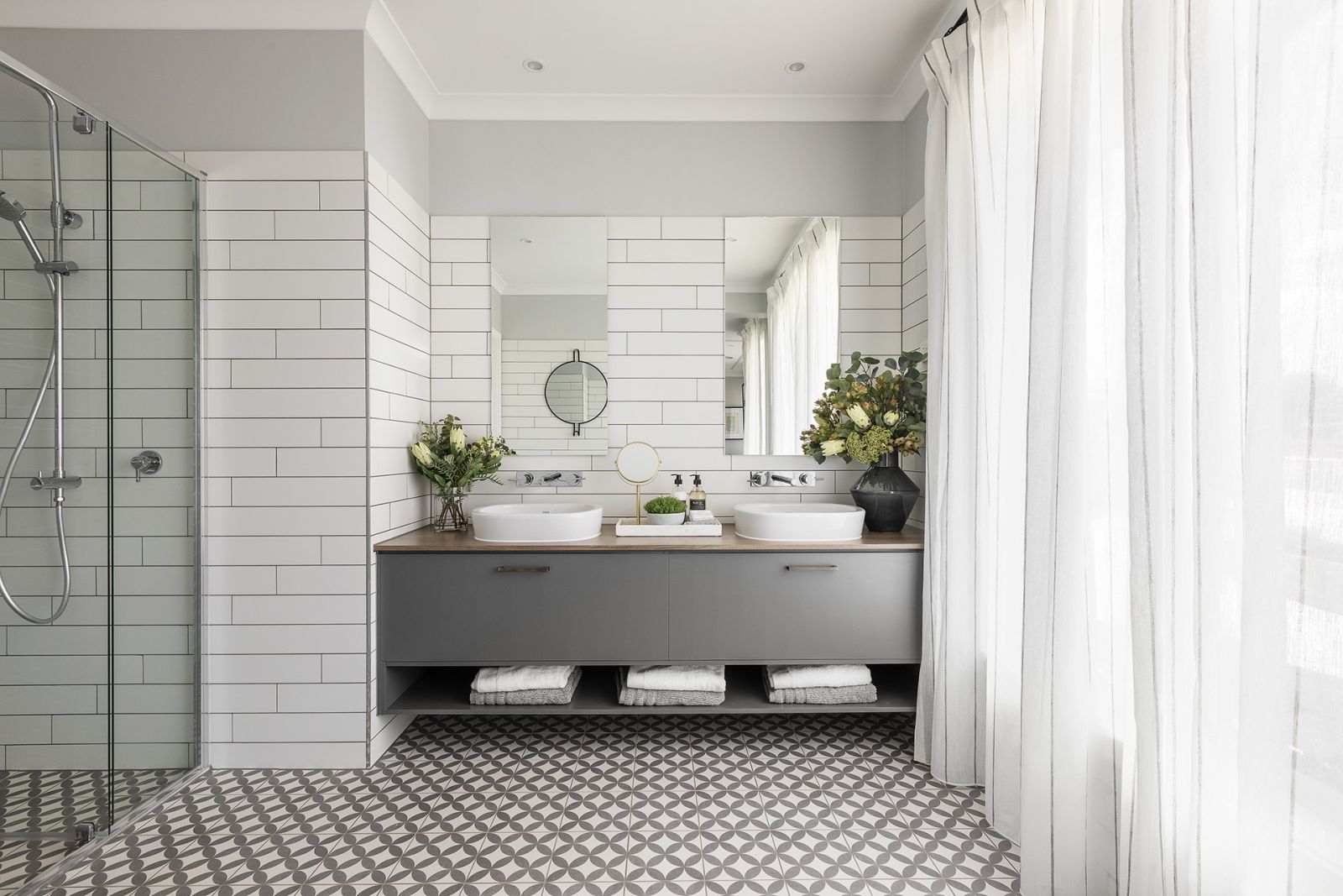 modern country bathroom design with blue and white mosaic floor tiles and floating vanity